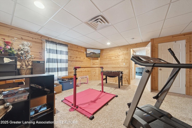 workout area with wooden walls, visible vents, a drop ceiling, carpet, and recessed lighting