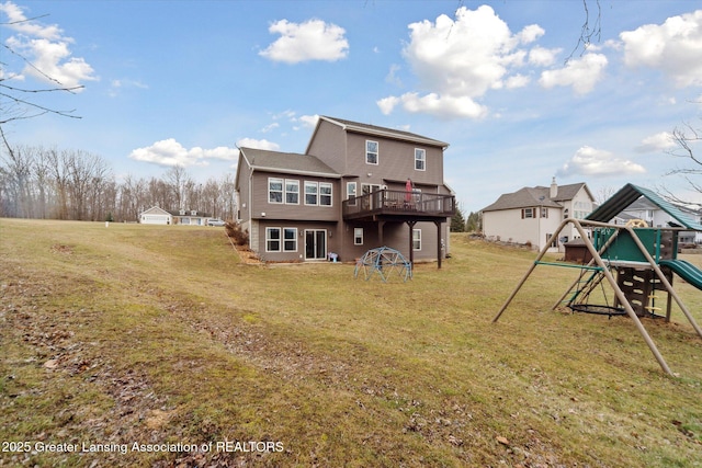 back of house with a playground, a lawn, and a wooden deck