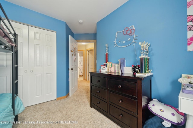 bedroom with a closet and light carpet