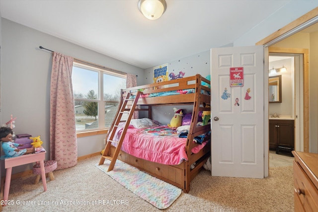 bedroom featuring light carpet, a sink, and baseboards