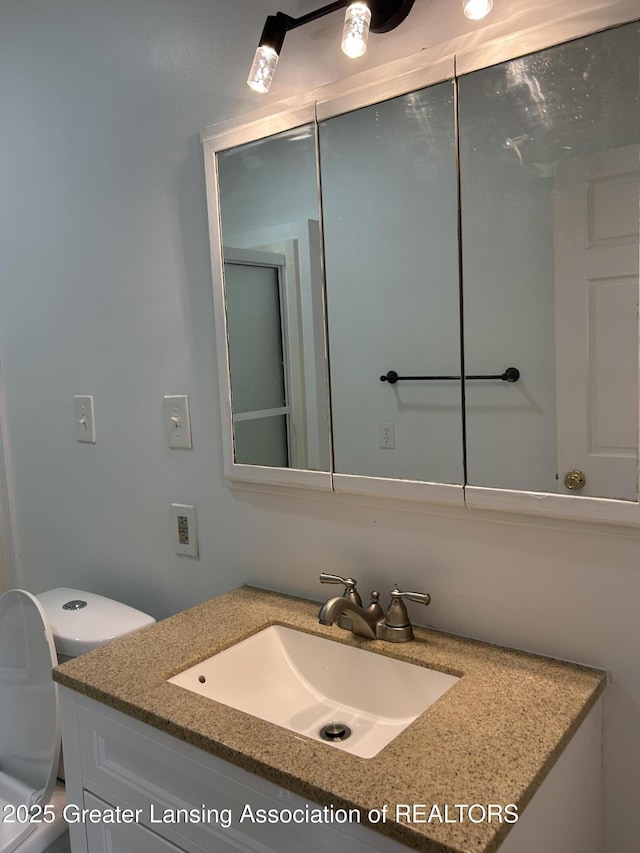 bathroom featuring toilet and vanity