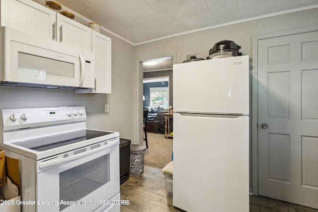 kitchen with white appliances, white cabinets, crown molding, and hardwood / wood-style floors