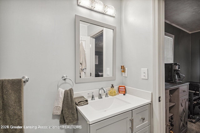 bathroom featuring ornamental molding and vanity