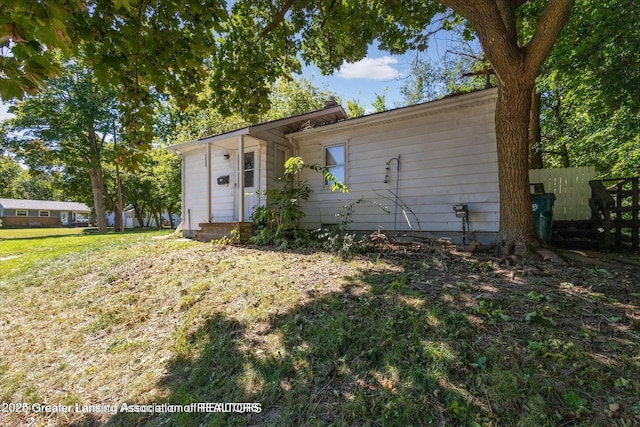 ranch-style home featuring a front yard and fence