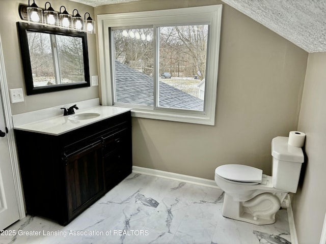 half bathroom featuring toilet, vanity, baseboards, vaulted ceiling, and marble finish floor