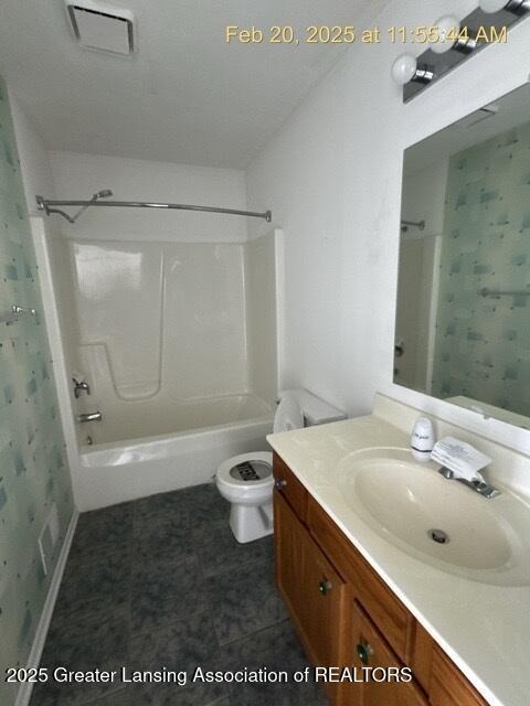 bathroom featuring toilet, visible vents, shower / washtub combination, and vanity