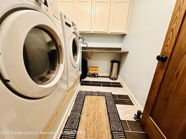 clothes washing area with tile patterned flooring, baseboards, cabinet space, and washing machine and clothes dryer