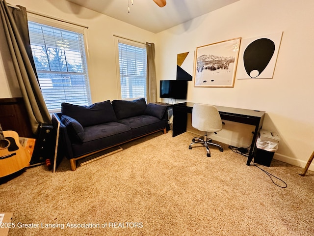 office space with carpet floors, baseboards, and a ceiling fan