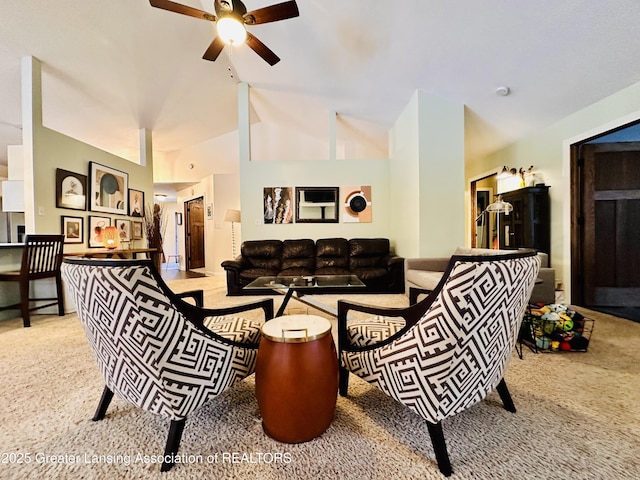 carpeted living room featuring high vaulted ceiling and a ceiling fan