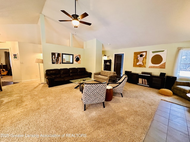 carpeted living area featuring high vaulted ceiling, tile patterned flooring, and a ceiling fan