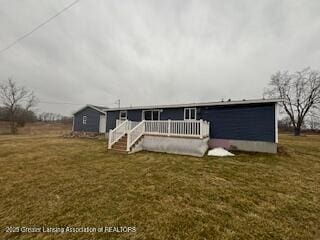 rear view of house with a yard