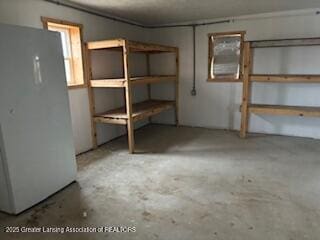 basement featuring freestanding refrigerator