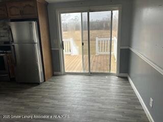 interior space featuring baseboards and dark wood-type flooring