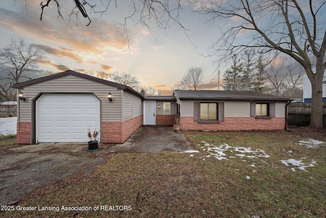 view of front facade featuring an attached garage and fence