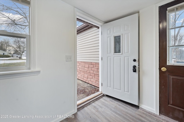 entryway with wood finished floors and baseboards