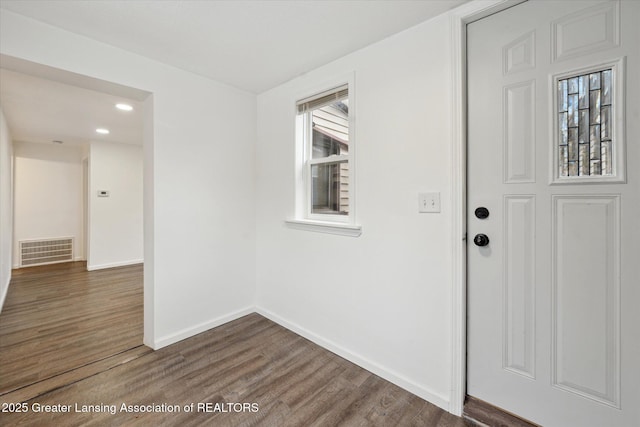 foyer featuring baseboards, visible vents, wood finished floors, and recessed lighting