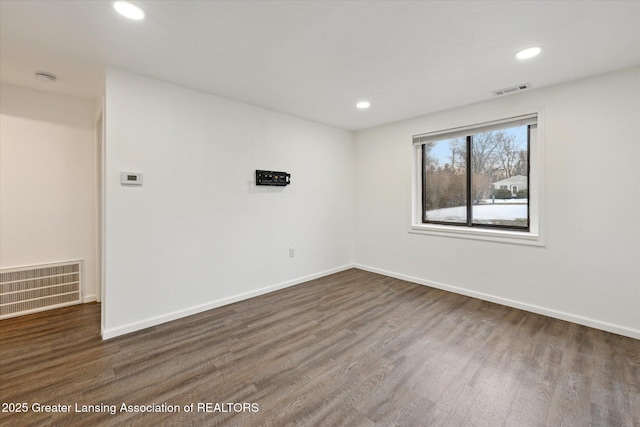 empty room with recessed lighting, visible vents, baseboards, and wood finished floors