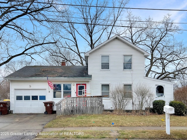 traditional home with a garage, driveway, a shingled roof, a chimney, and a front yard