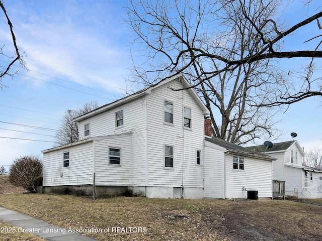 view of side of property with central AC unit