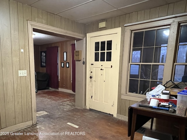 entryway with wood walls