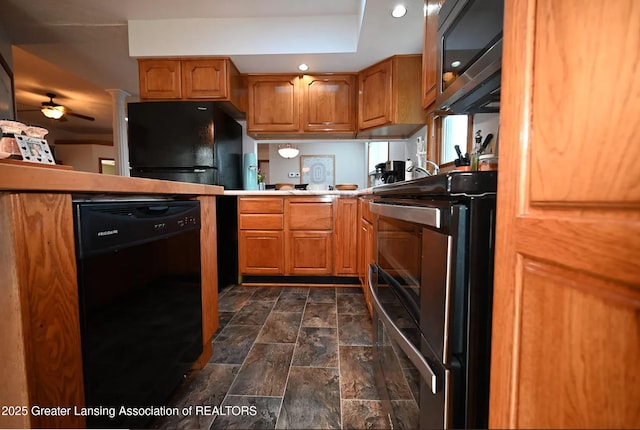 kitchen with black appliances, stone finish flooring, brown cabinetry, and light countertops