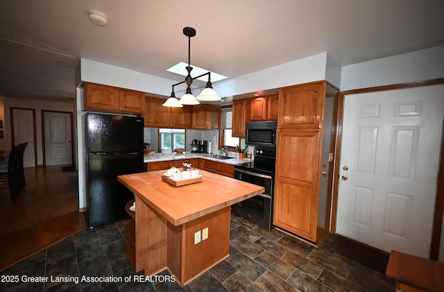 kitchen with freestanding refrigerator, stone finish floor, double oven range, and wood counters