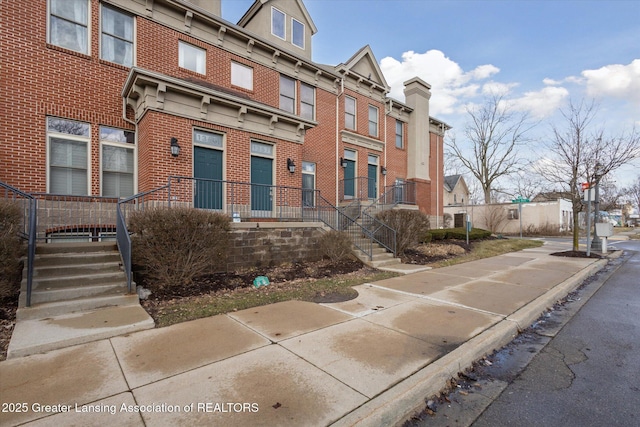 view of front facade featuring brick siding and a residential view