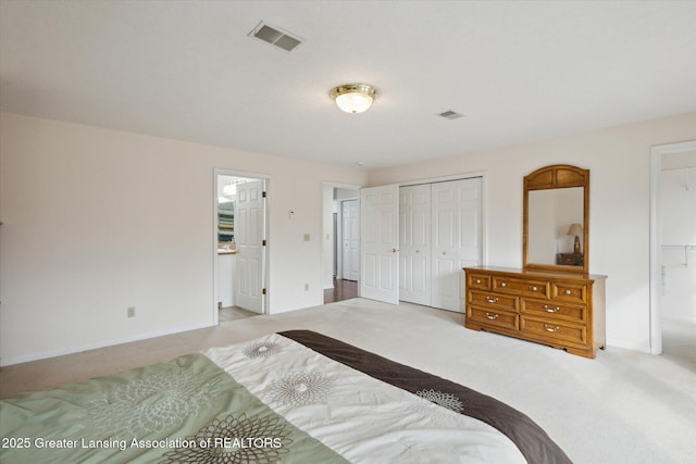 bedroom with carpet floors, a closet, visible vents, and baseboards