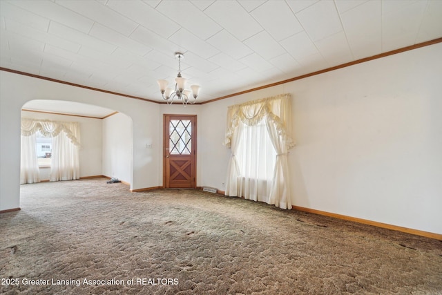 carpeted foyer with baseboards and a healthy amount of sunlight