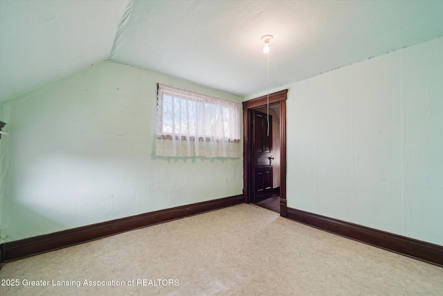 additional living space with vaulted ceiling, carpet, and baseboards