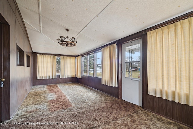 unfurnished sunroom with lofted ceiling