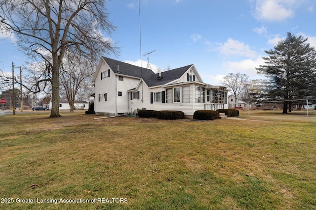 view of home's exterior with a yard and a shingled roof