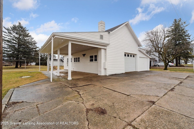 view of property exterior featuring driveway, a yard, and a chimney