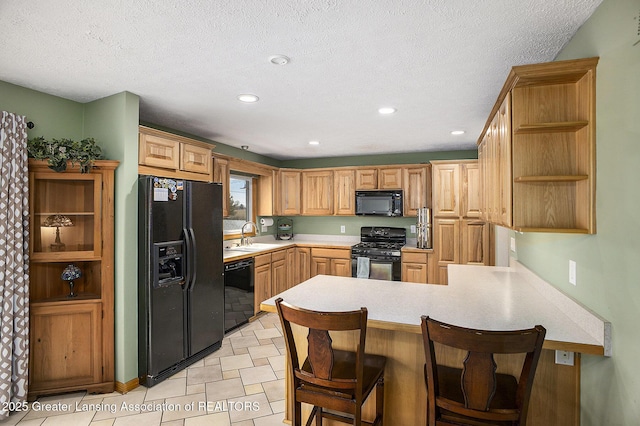 kitchen featuring a peninsula, light countertops, black appliances, open shelves, and recessed lighting