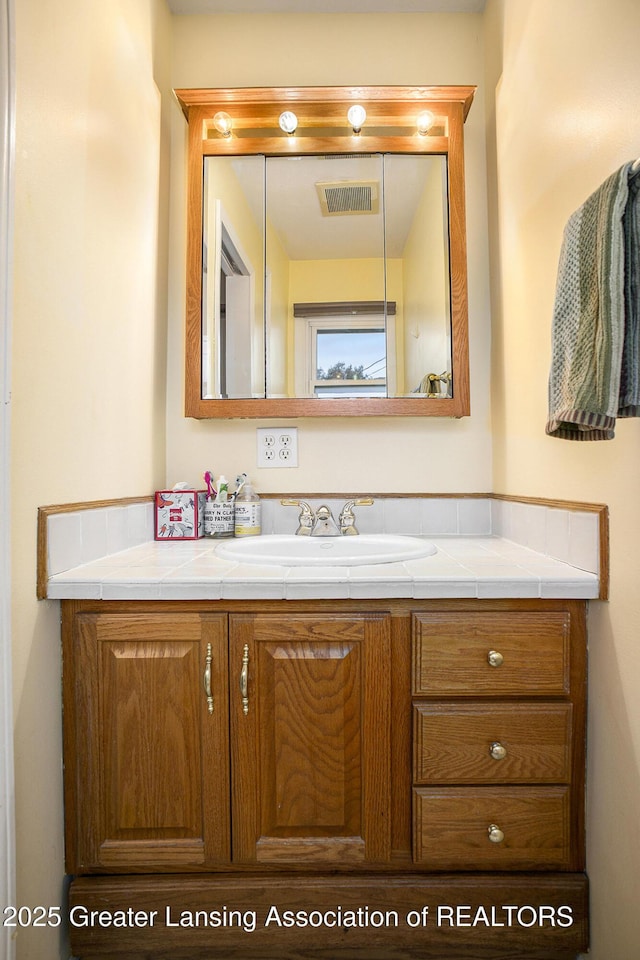 bathroom featuring visible vents and vanity