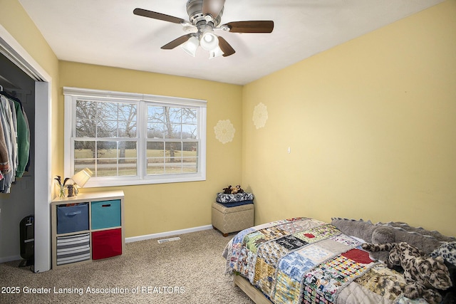 carpeted bedroom with ceiling fan, a closet, visible vents, and baseboards