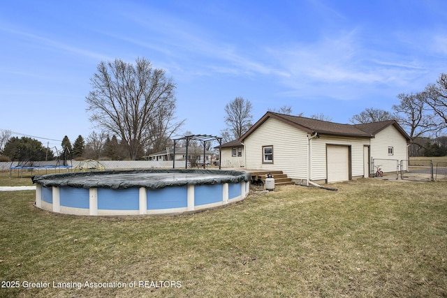 view of pool with a yard, a pergola, fence, and a covered pool