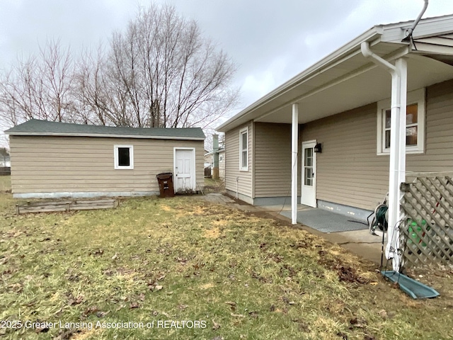 exterior space with an outbuilding, a yard, and a patio