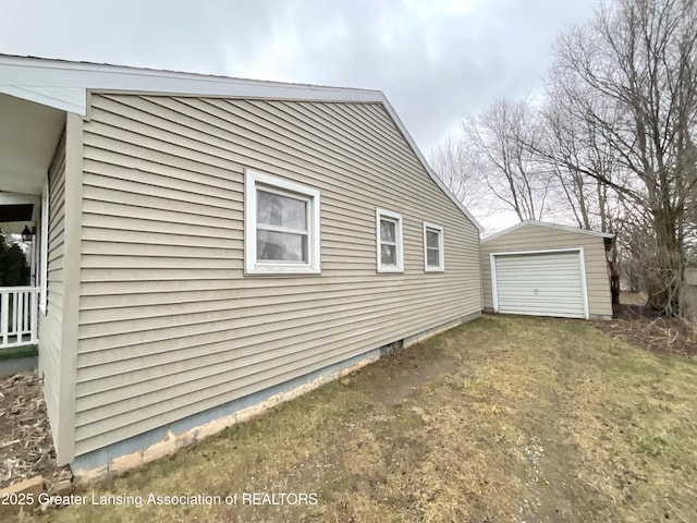 view of property exterior featuring driveway, a detached garage, and an outdoor structure