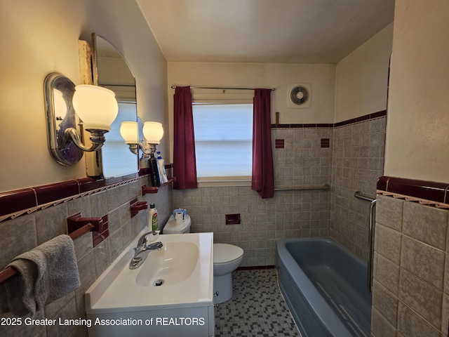 full bathroom with toilet, a bathtub, visible vents, and tile walls