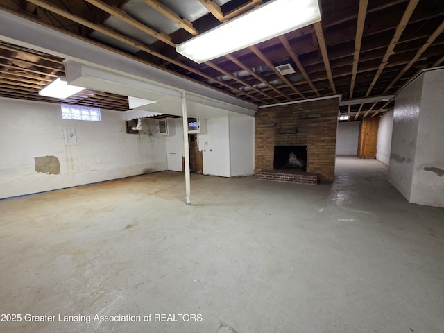 below grade area featuring a brick fireplace and visible vents