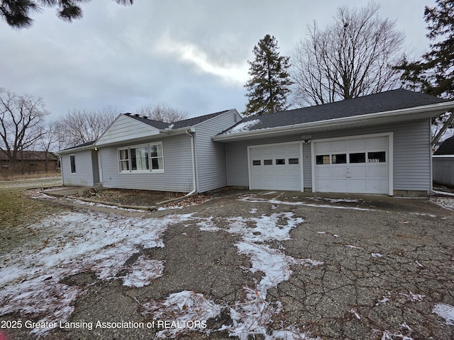 view of front of home with aphalt driveway and an attached garage