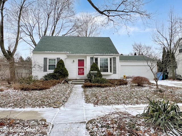 cape cod-style house featuring entry steps, a garage, and roof with shingles