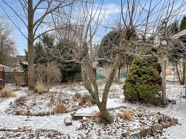 yard covered in snow with fence