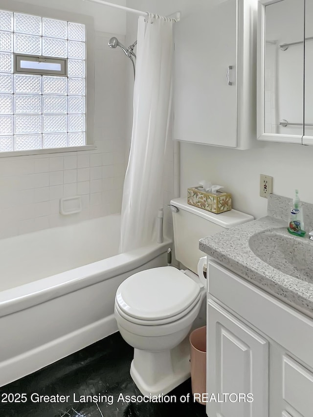 bathroom featuring toilet, shower / bath combo with shower curtain, and vanity