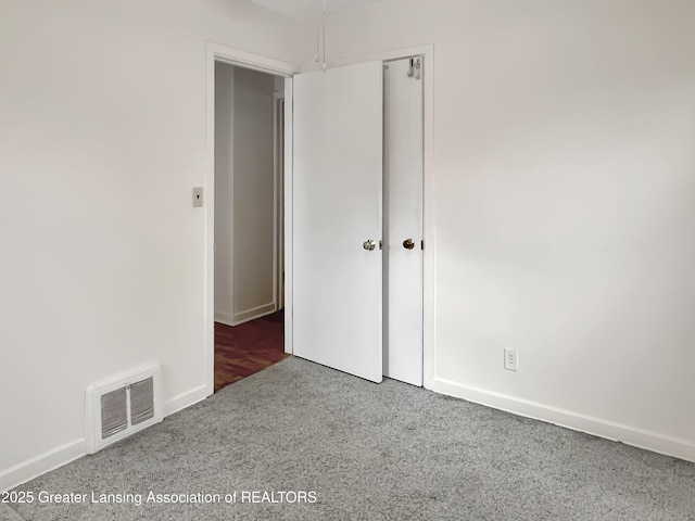 unfurnished bedroom with visible vents and baseboards