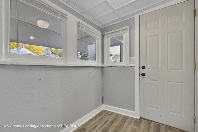 entryway featuring baseboards and wood finished floors