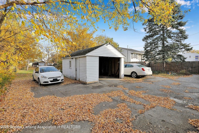 view of outbuilding featuring an outdoor structure and fence