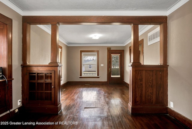 entryway with baseboards, visible vents, dark wood finished floors, and ornamental molding