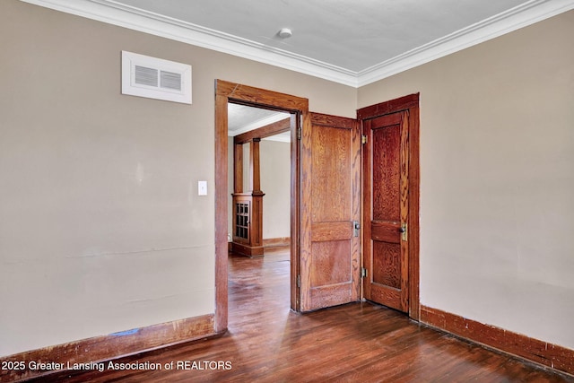 unfurnished room with ornamental molding, visible vents, and dark wood-type flooring